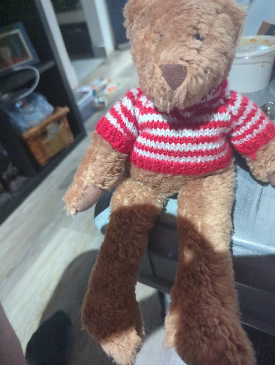 Brown teddy bear with red and white striped sweater
