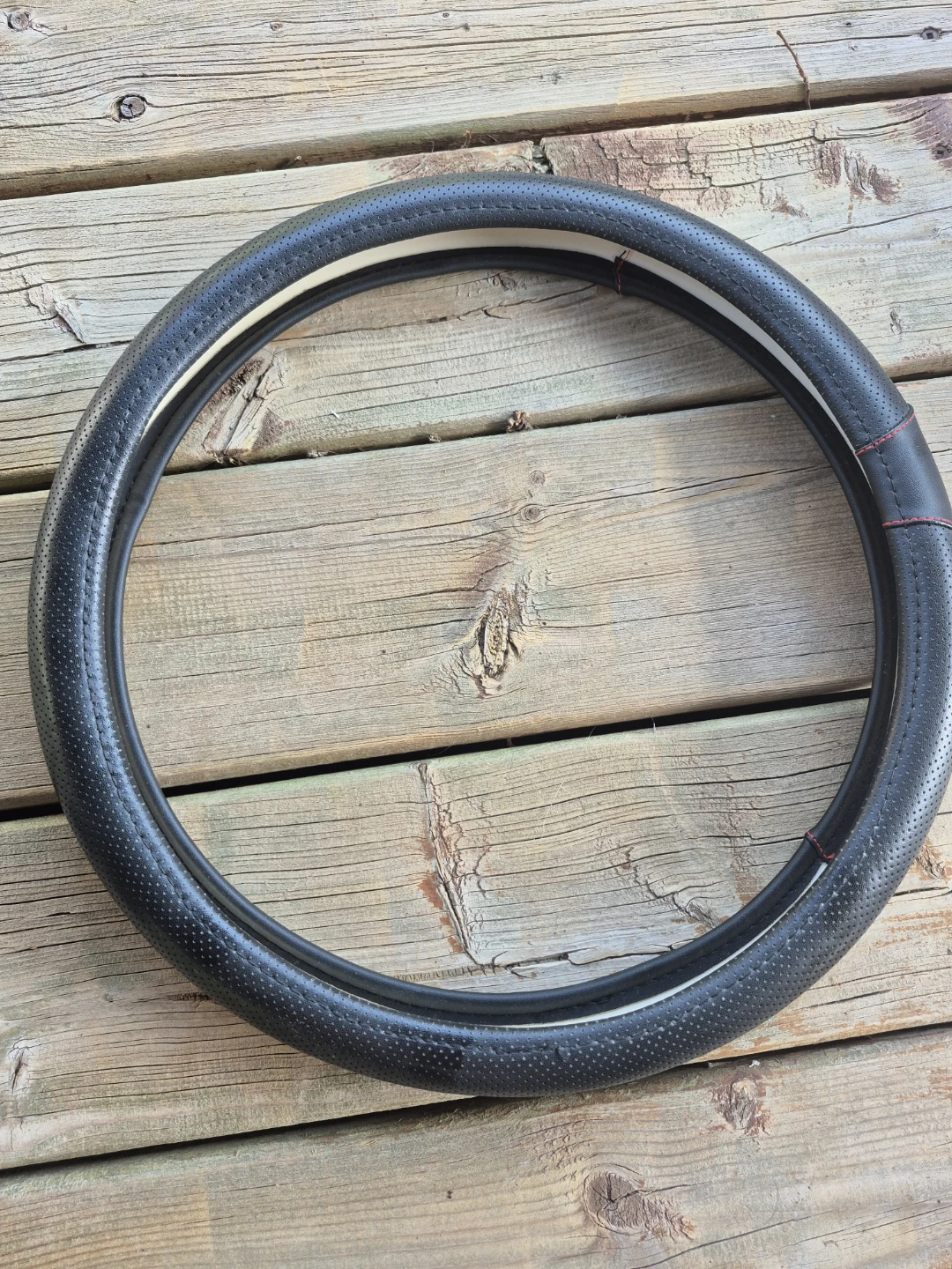 Black faux-leather steering wheel cover