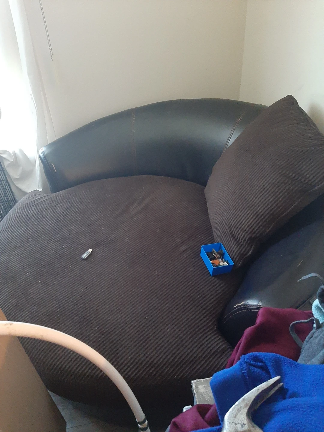 Brown cuddle chair fits 2 people with  black leather accents