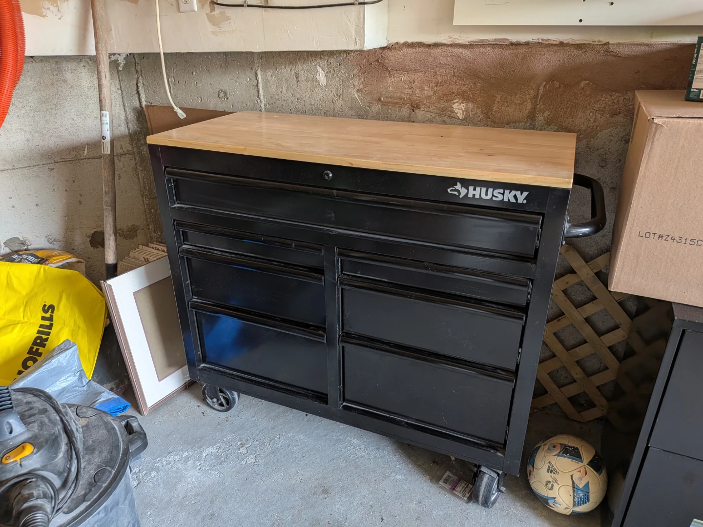 Husky black rolling tool chest with wood top