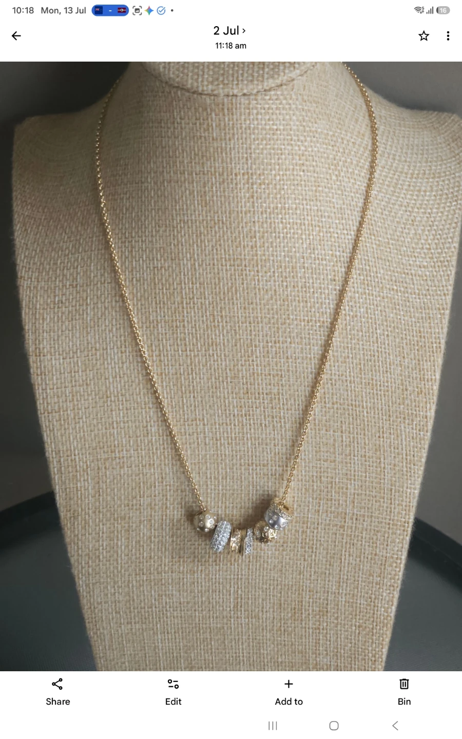 Gold-tone necklace with decorative charms