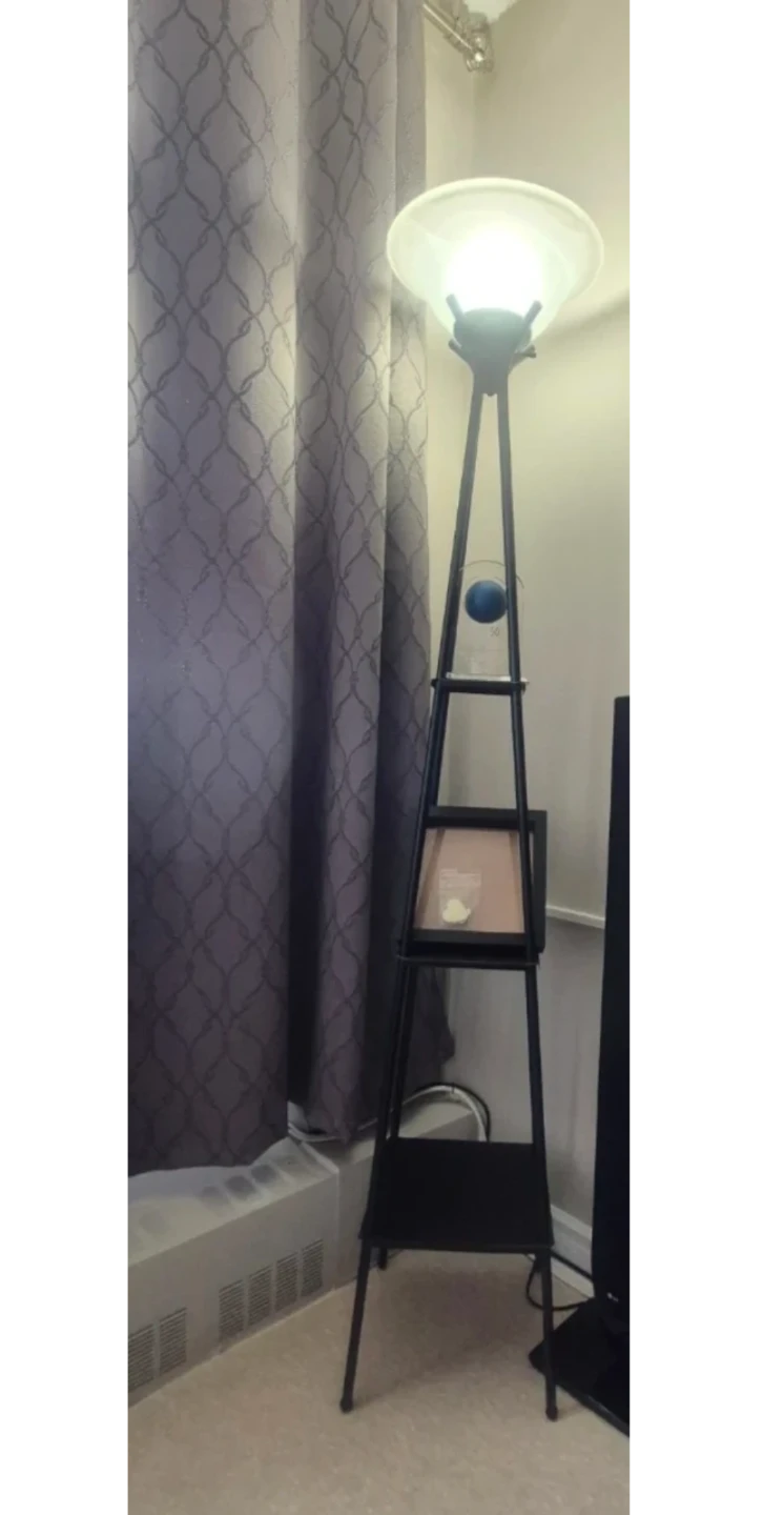 Tall black floor lamp with shelves