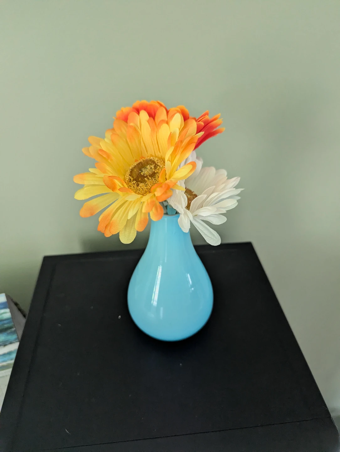 Faux flowers and blue vase