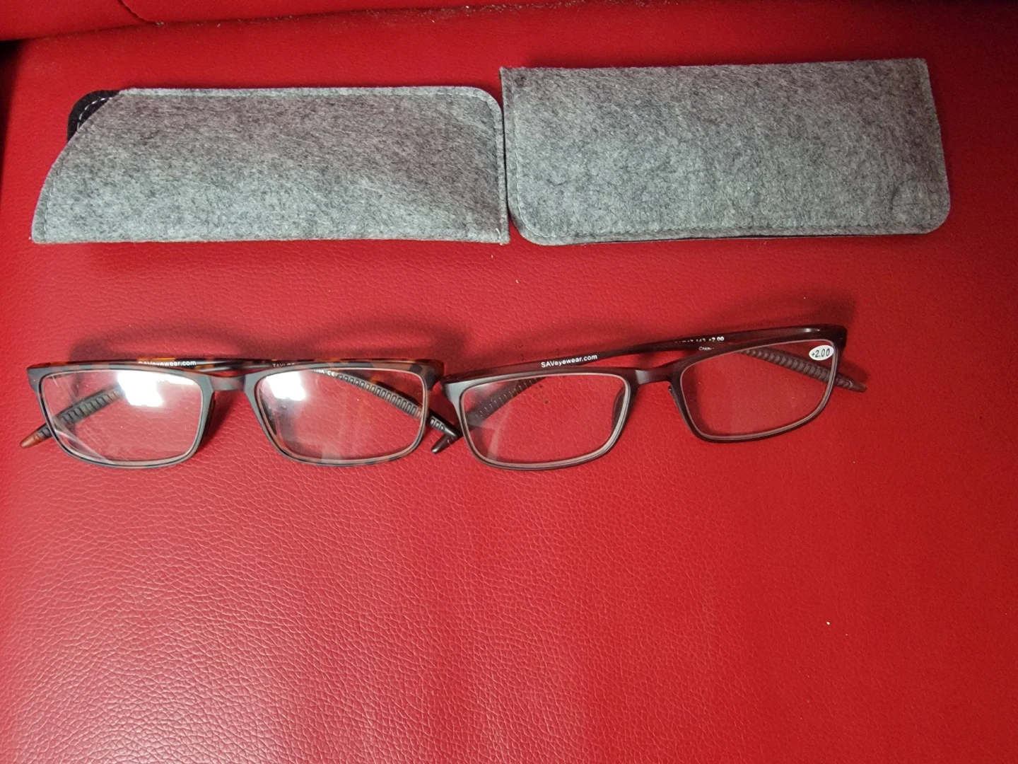 Two pairs of reading glasses with cases