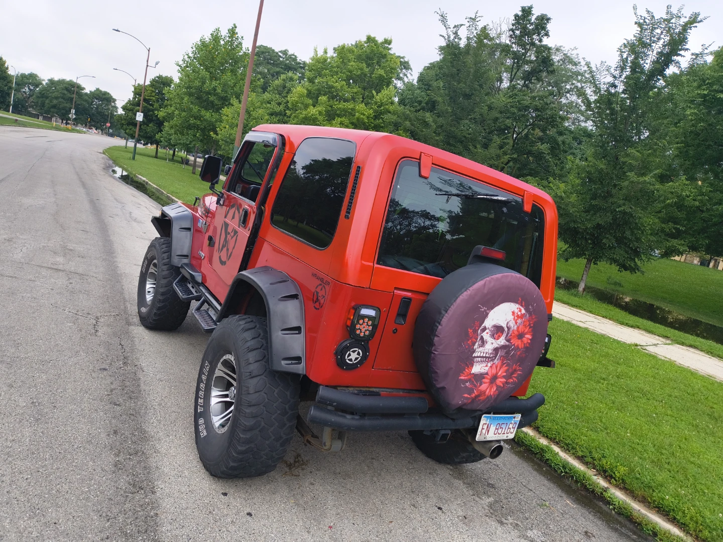 Red Jeep Wrangler with Custom Spare Tire Cover