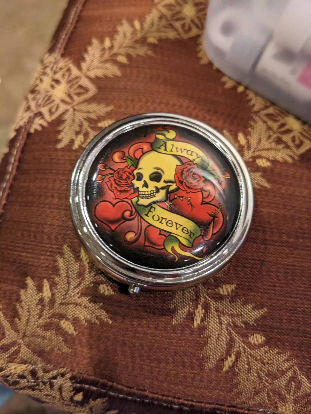 Round Pill Case with Skull and Roses Design
