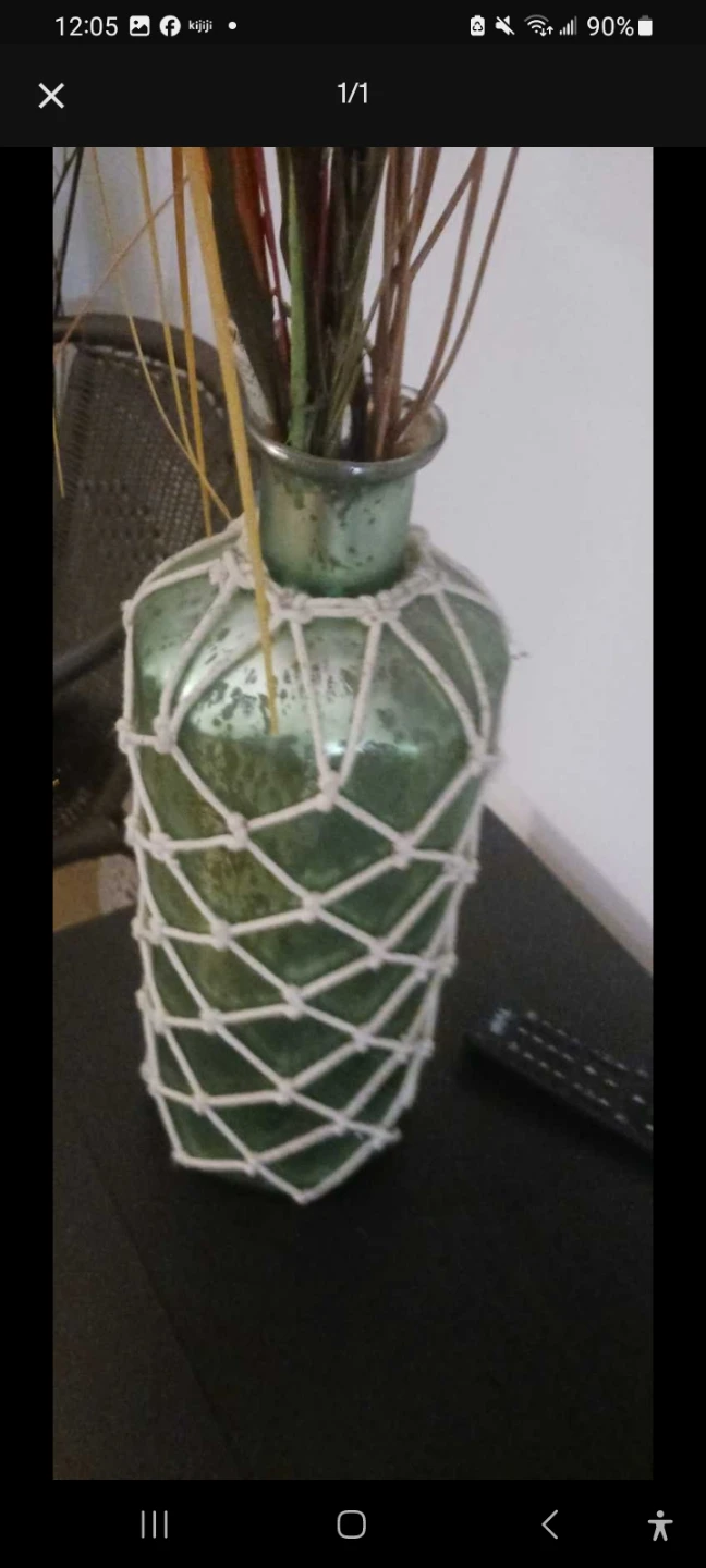 Green glass vase with macrame netting