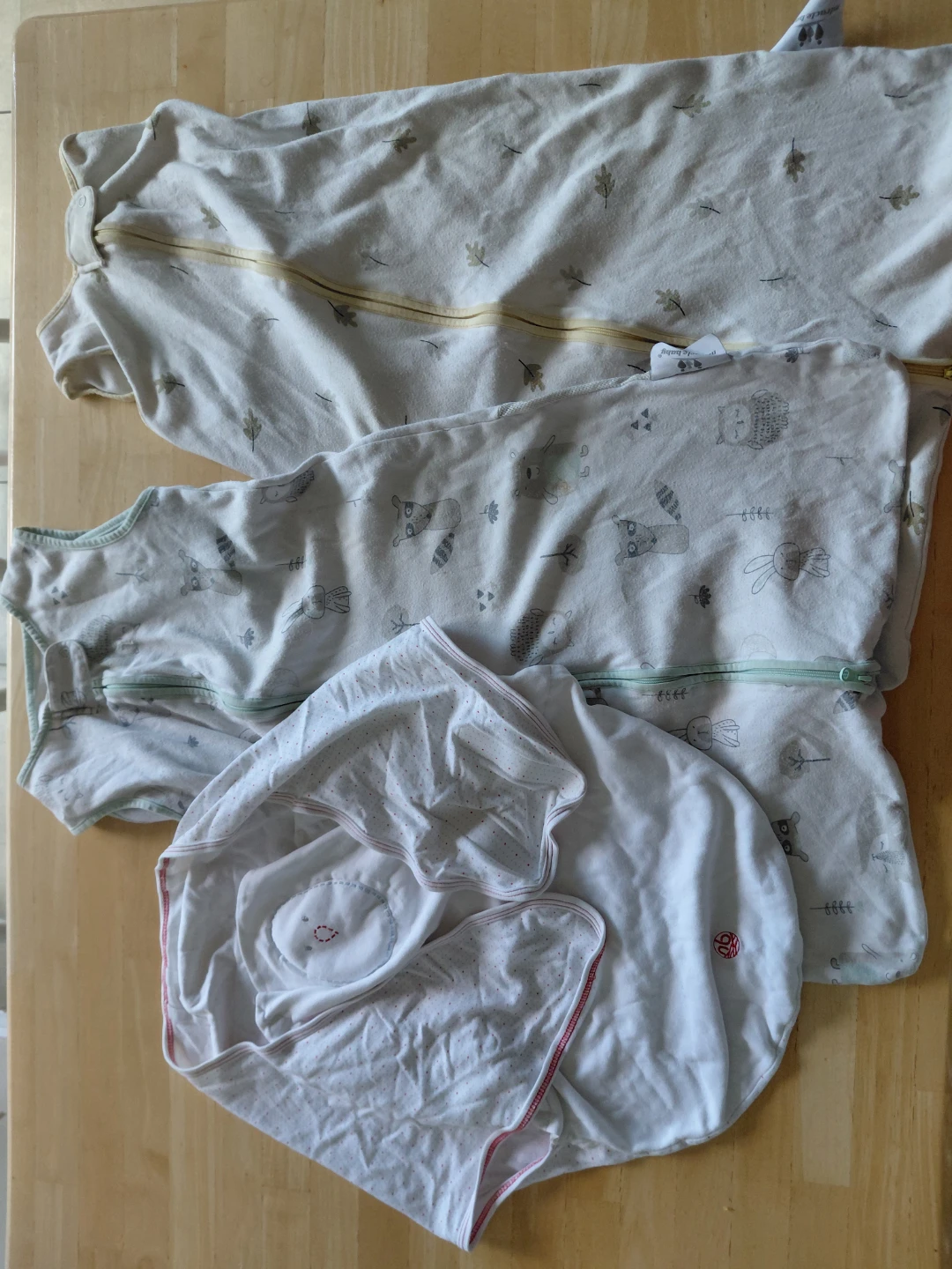 Two baby sleep sacks and newborn swaddle