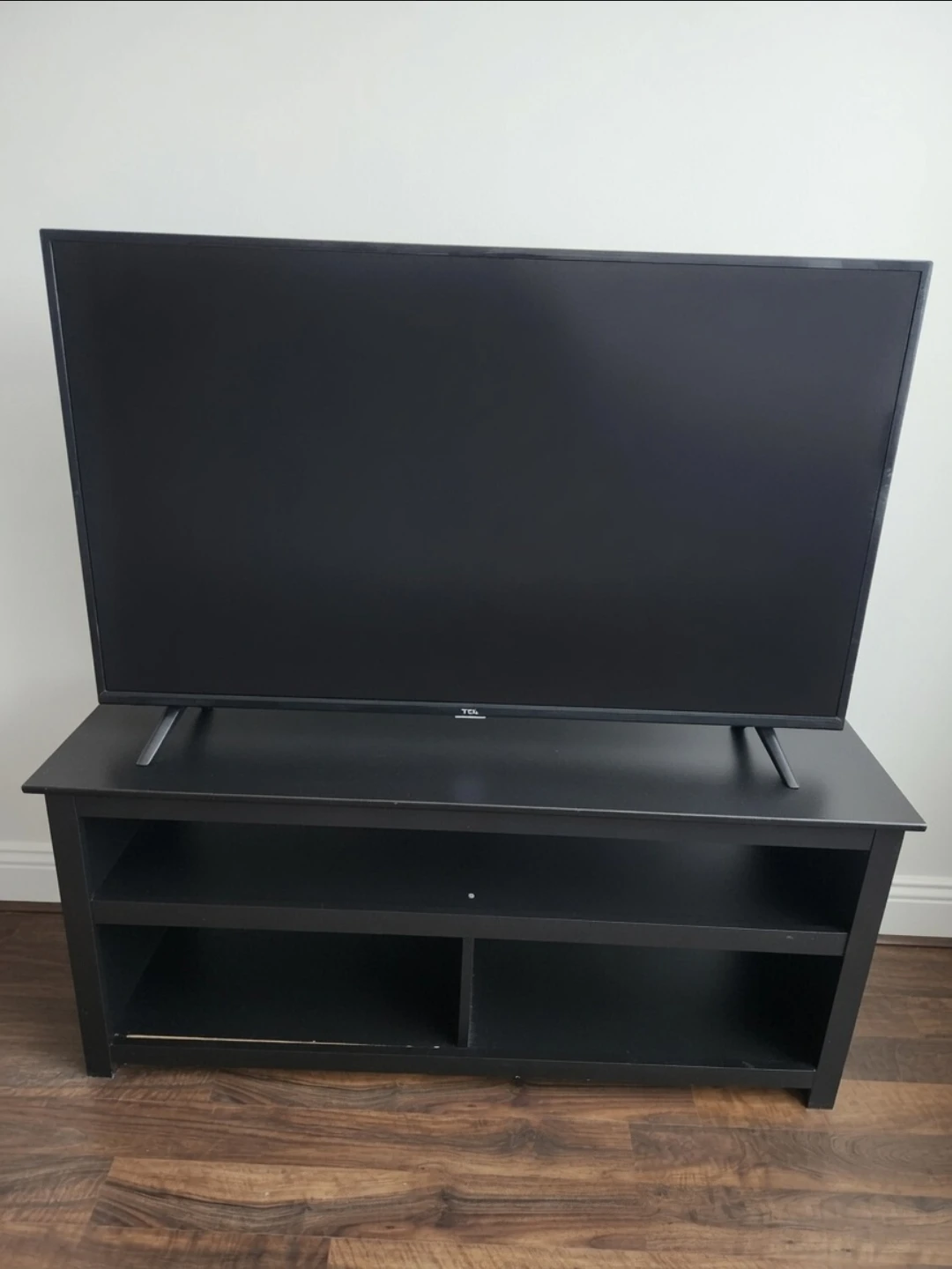 TCL Roku TV with black TV Stand