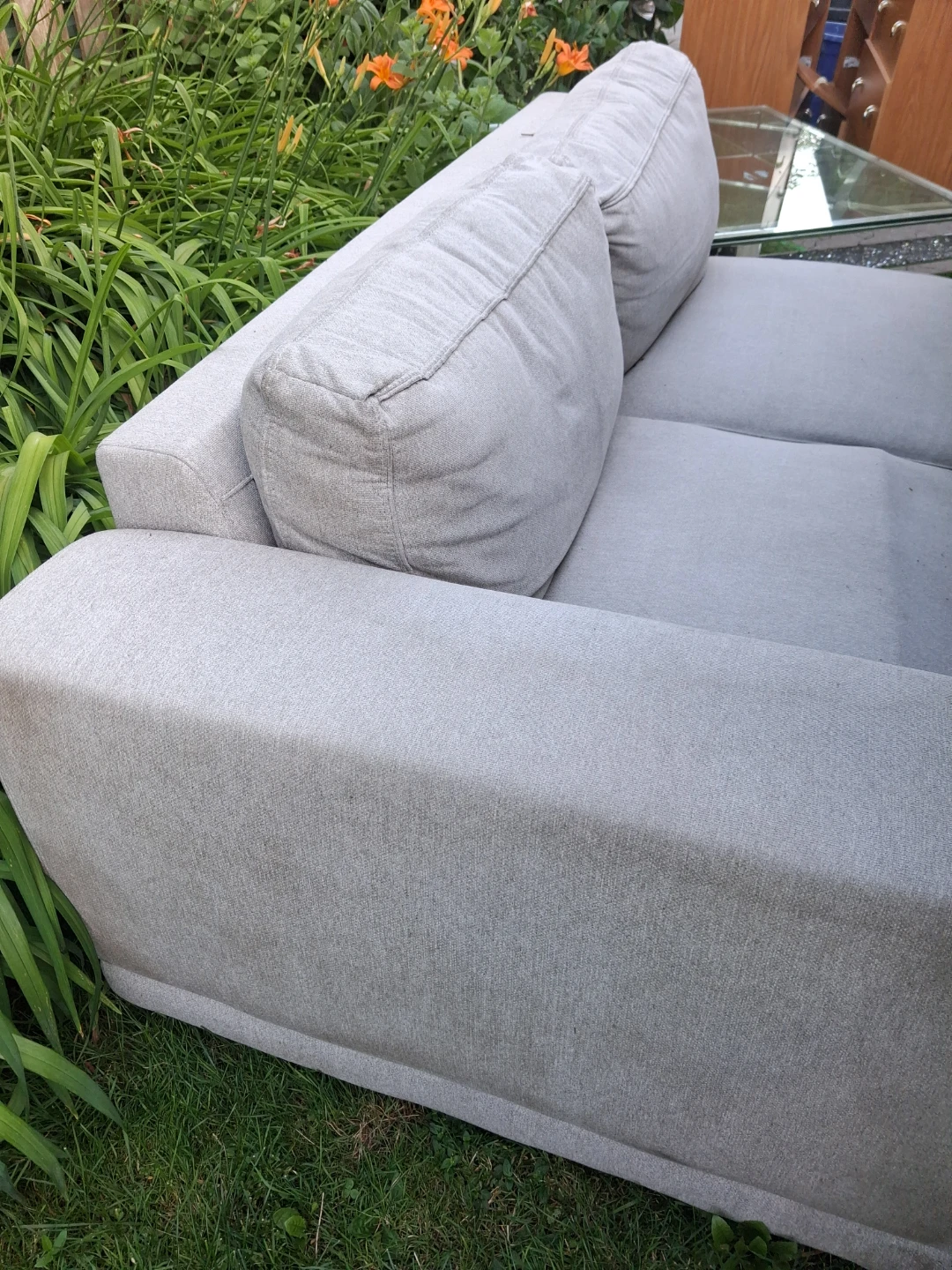 Grey fabric sofa with throw pillow