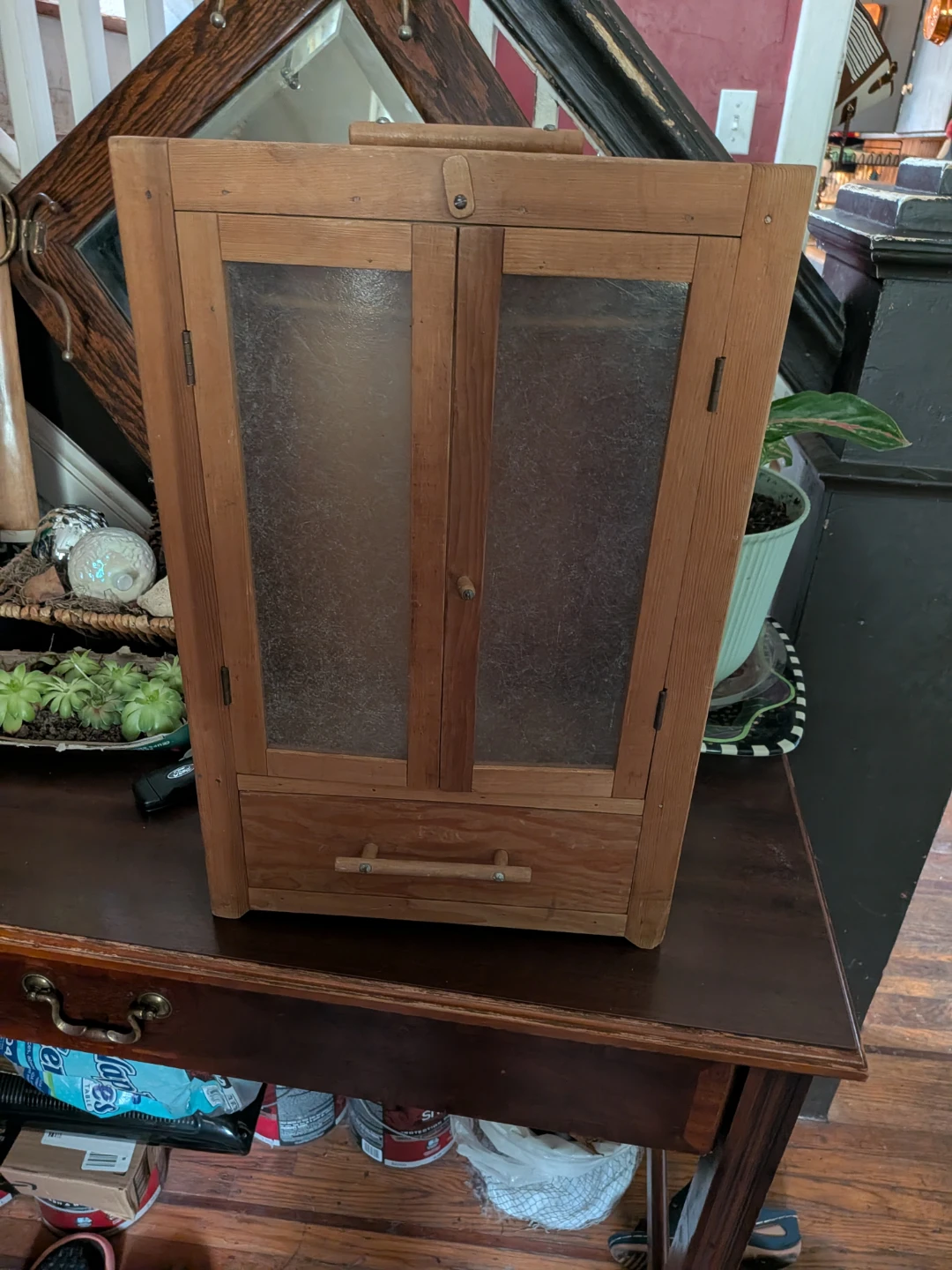 Wooden wall cabinet. Two doors and drawer underneath.