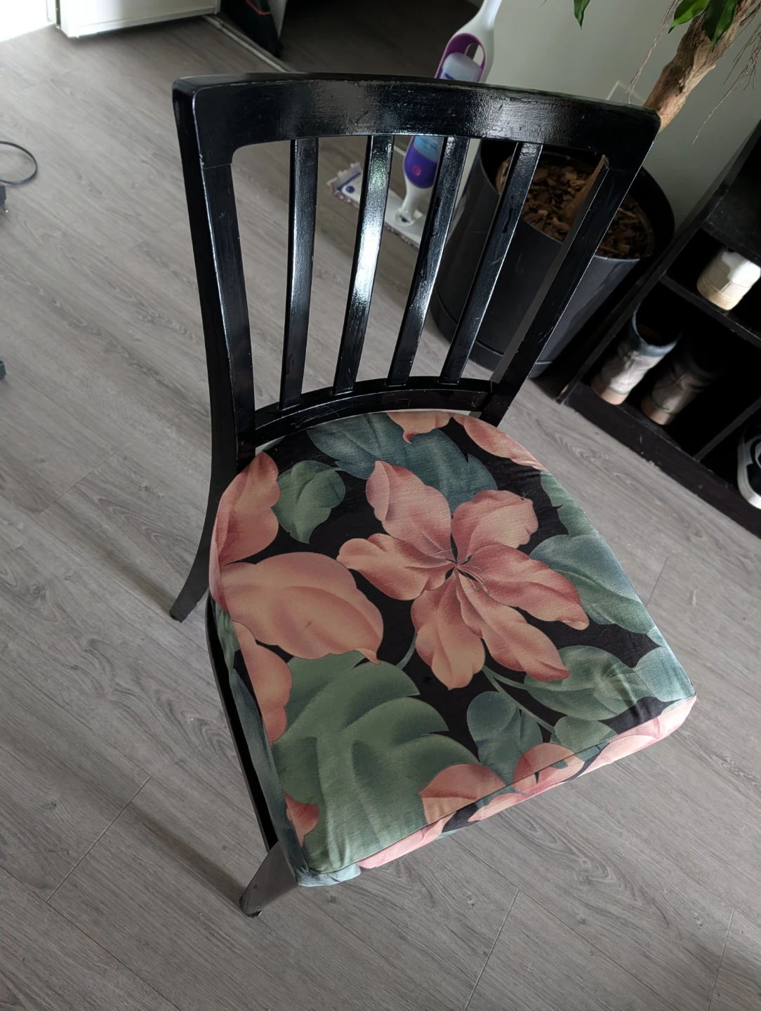 Black wooden chair with floral cushion