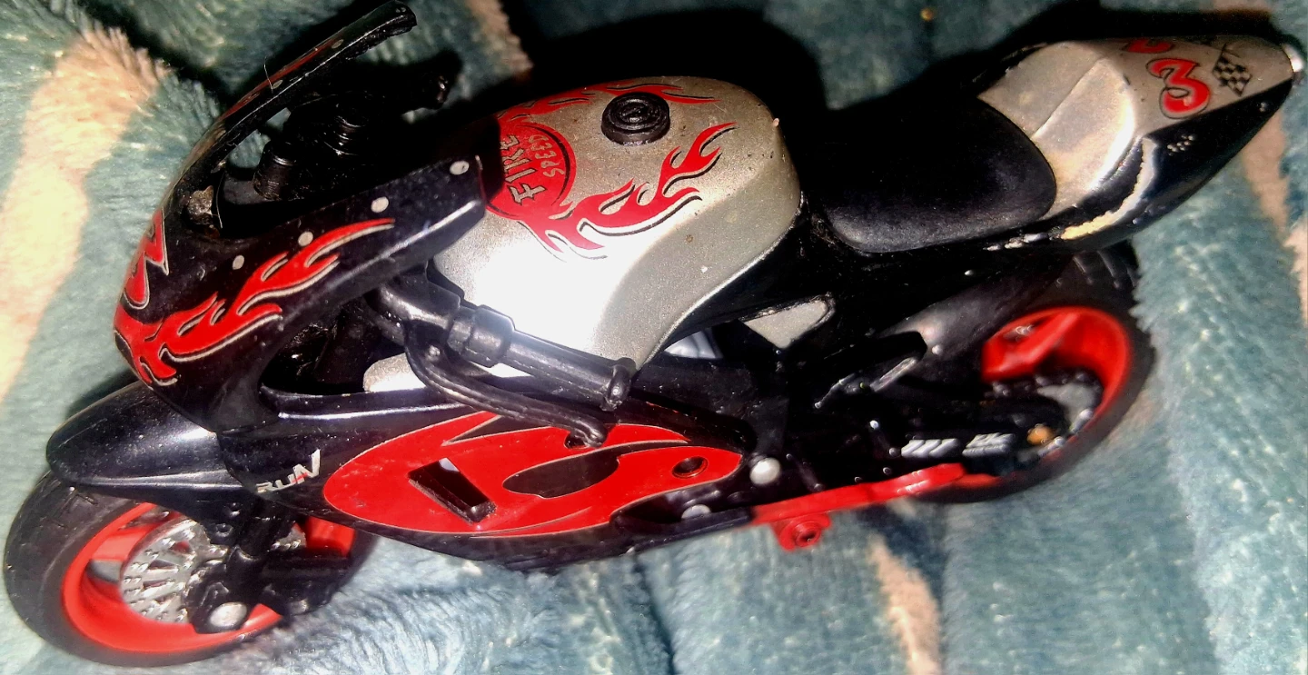 Toy Motorcycle with Fire Decals A Bit Damaged