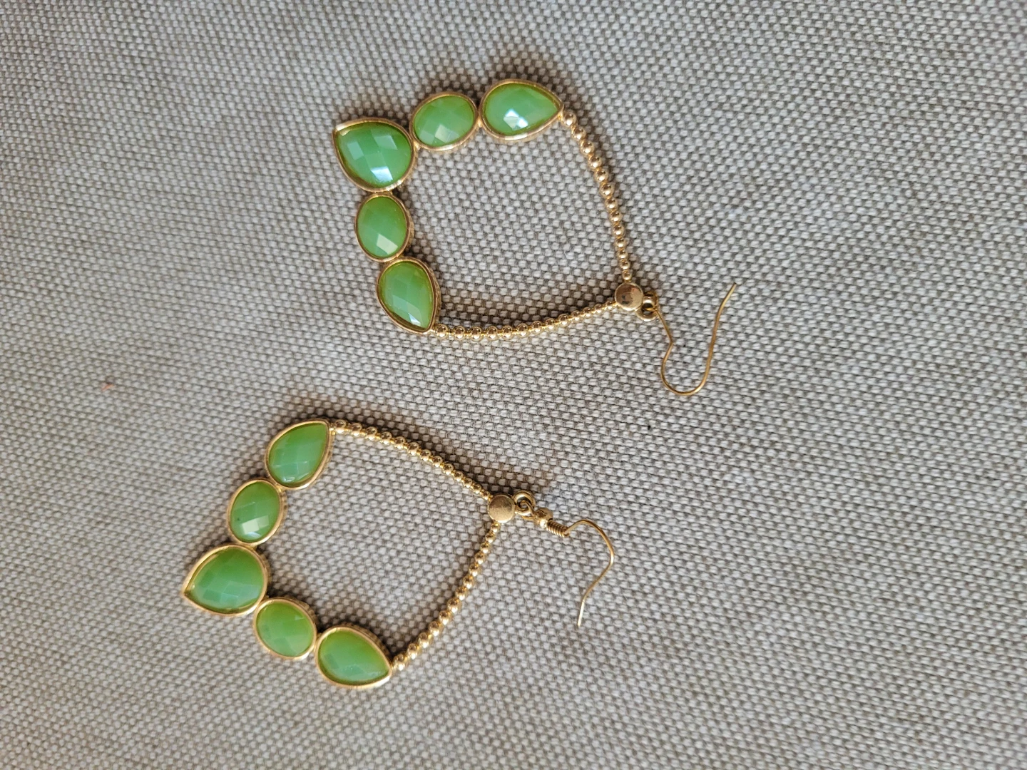 Gold tone green dangle earrings