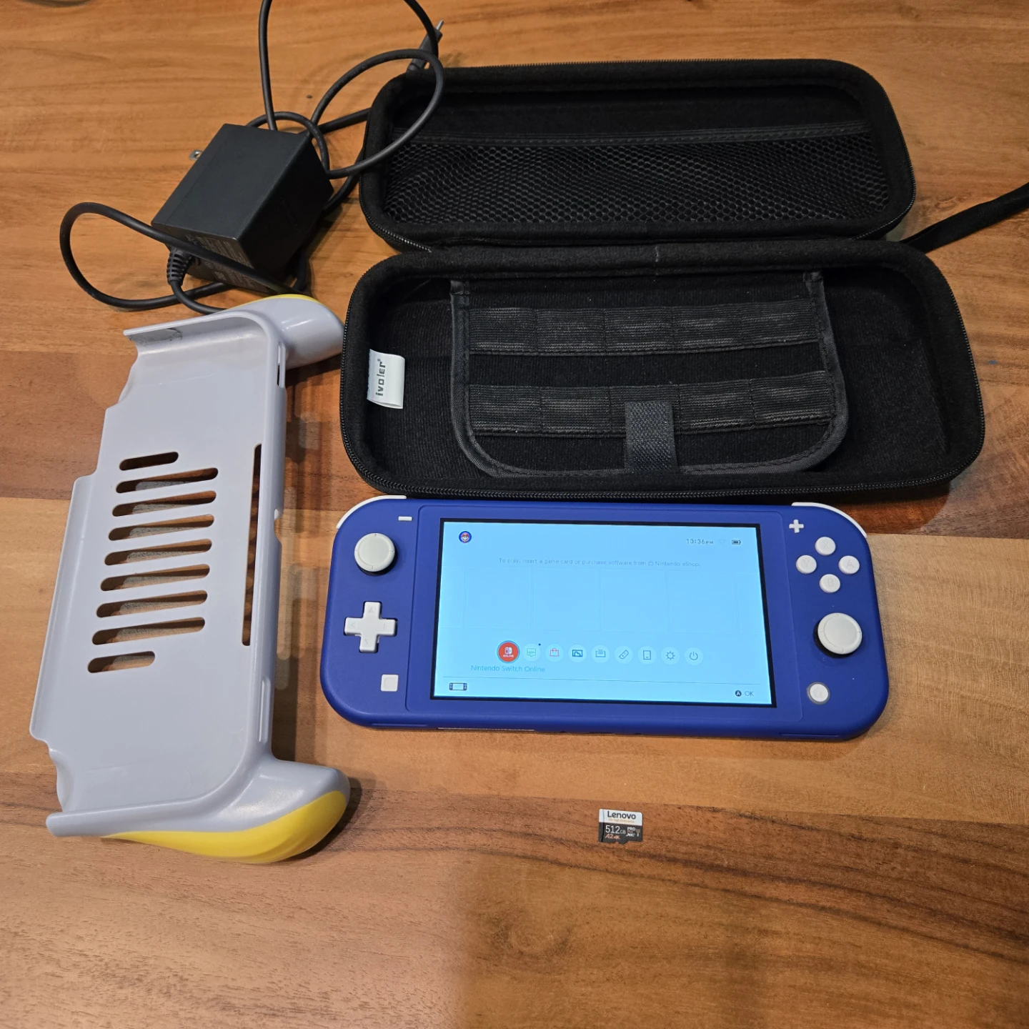 Nintendo Switch Lite. Original charger, case, grip, sd card.