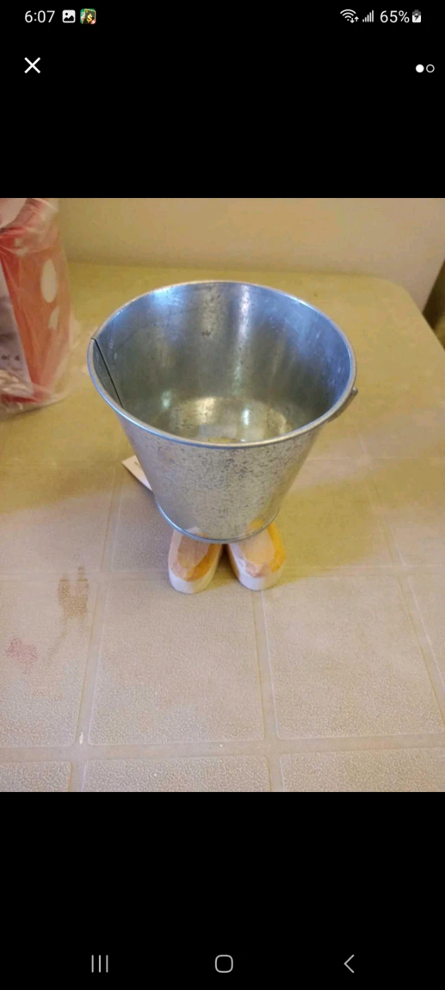 Galvanized metal bucket with wooden feet