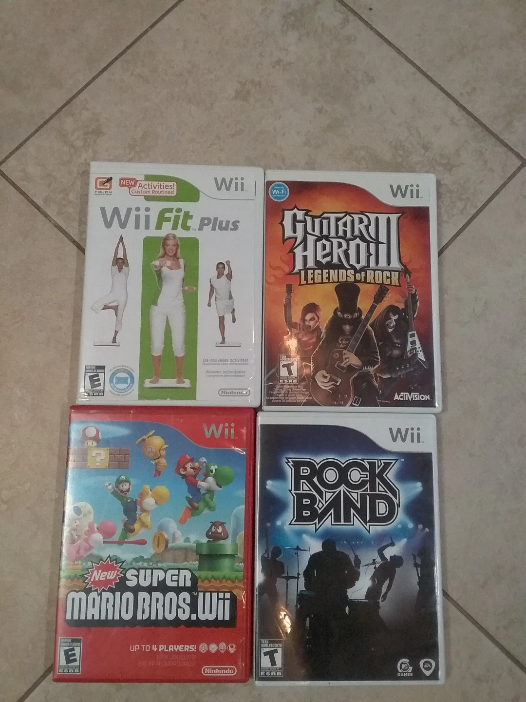 Wii, Super Mario Bros., Wii fit, and Rock Band Video Games