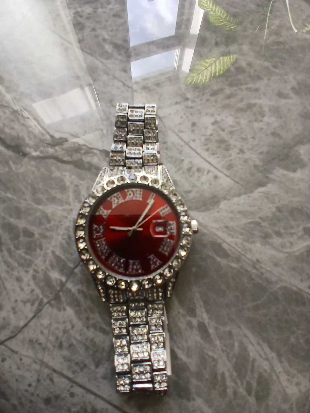 Iced out silver tone watch red face