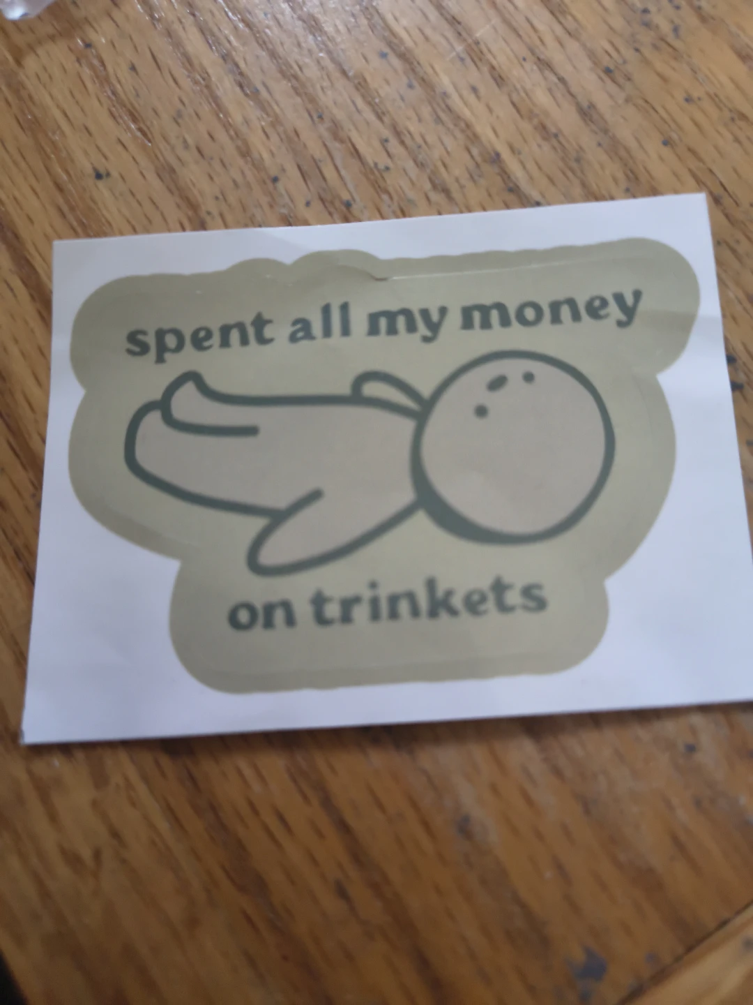 Sticker: "spent all my money on trinkets"