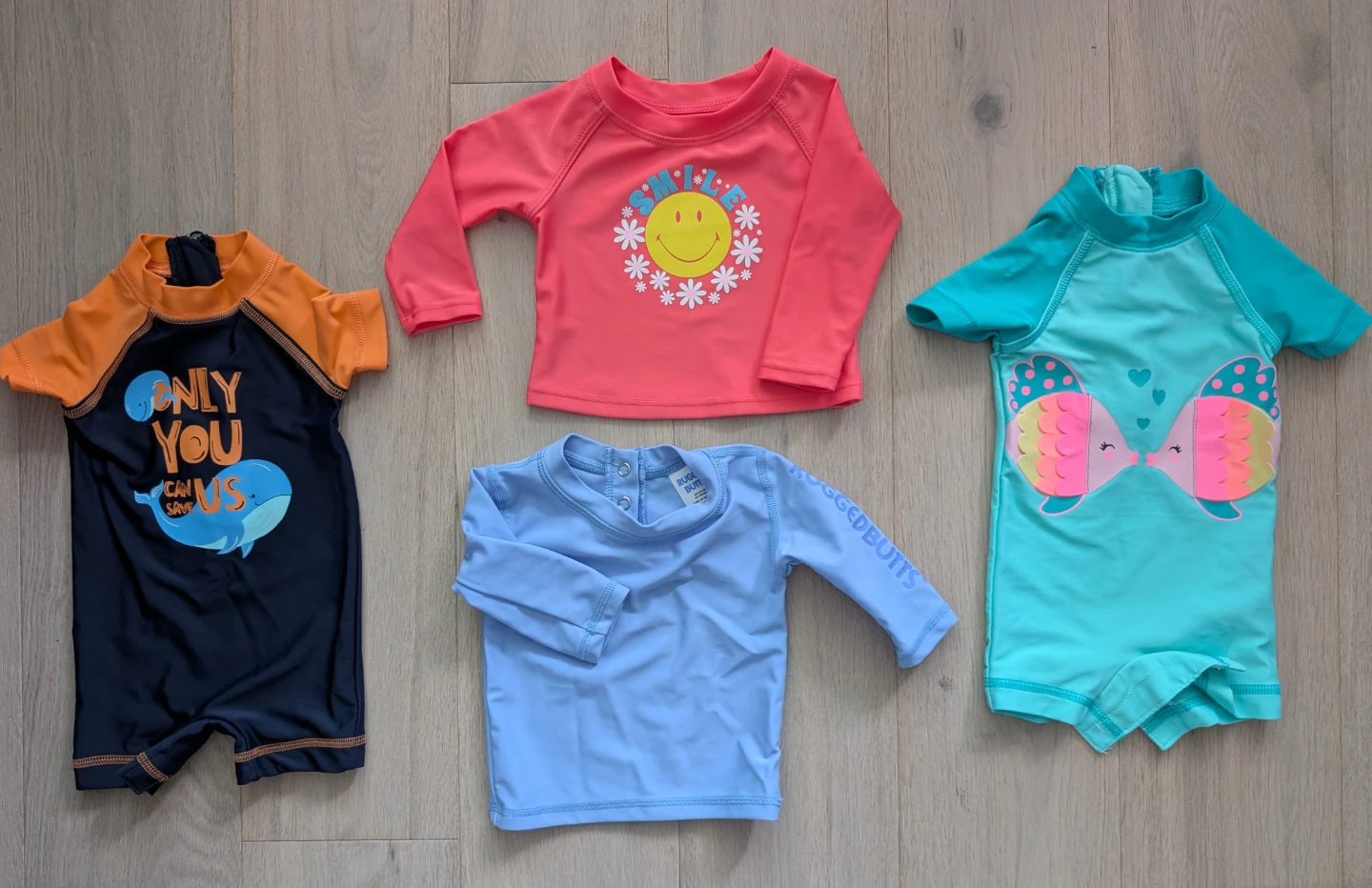 Bundle of 4 kids' rash guards and swimsuits