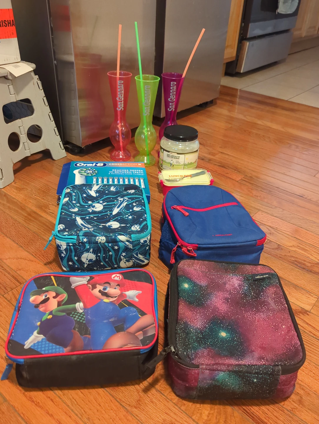 Assorted Lunch Boxes, Cups, and Oral-B Toothbrushes