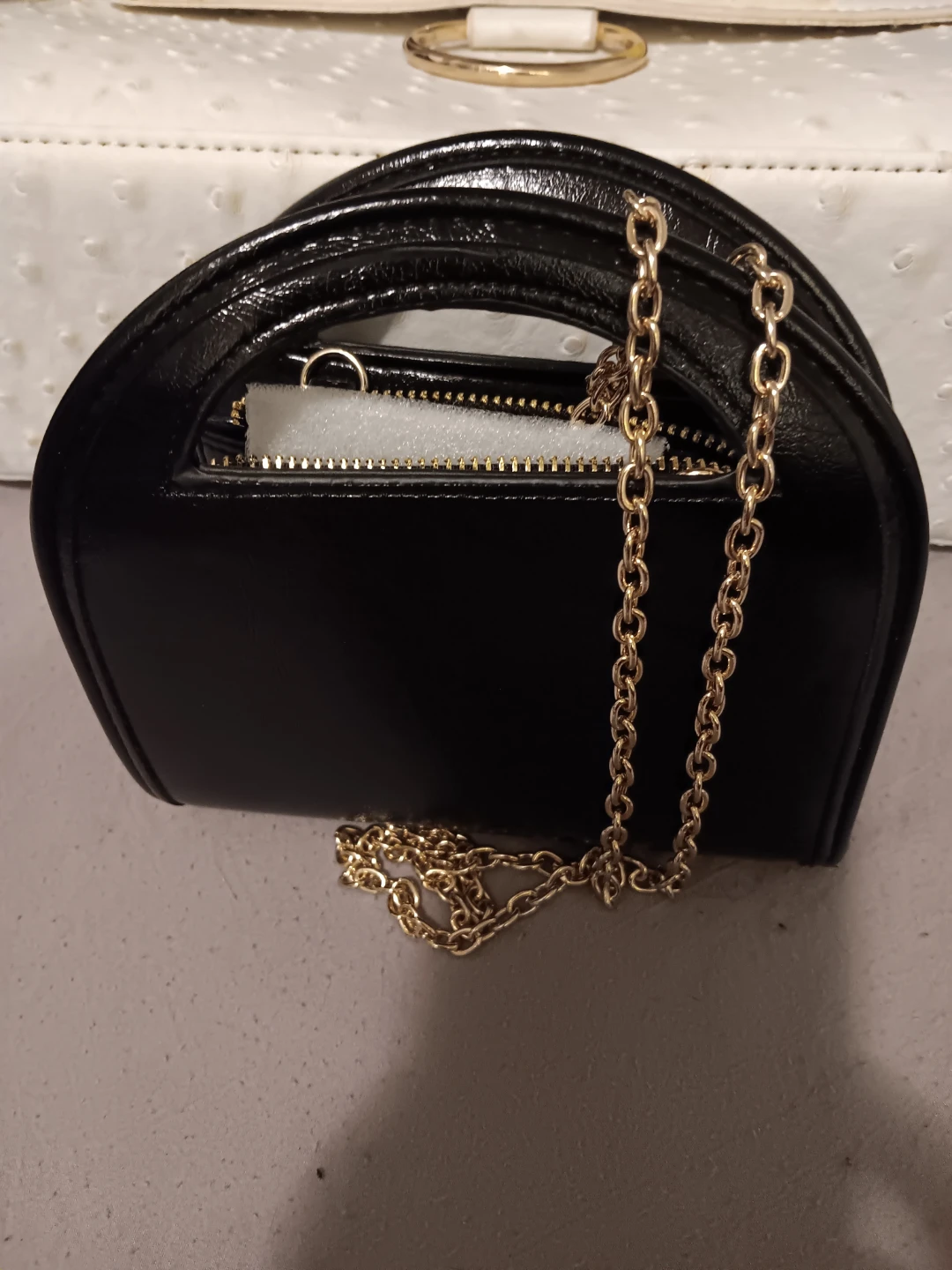 Black patent handbag with gold chain