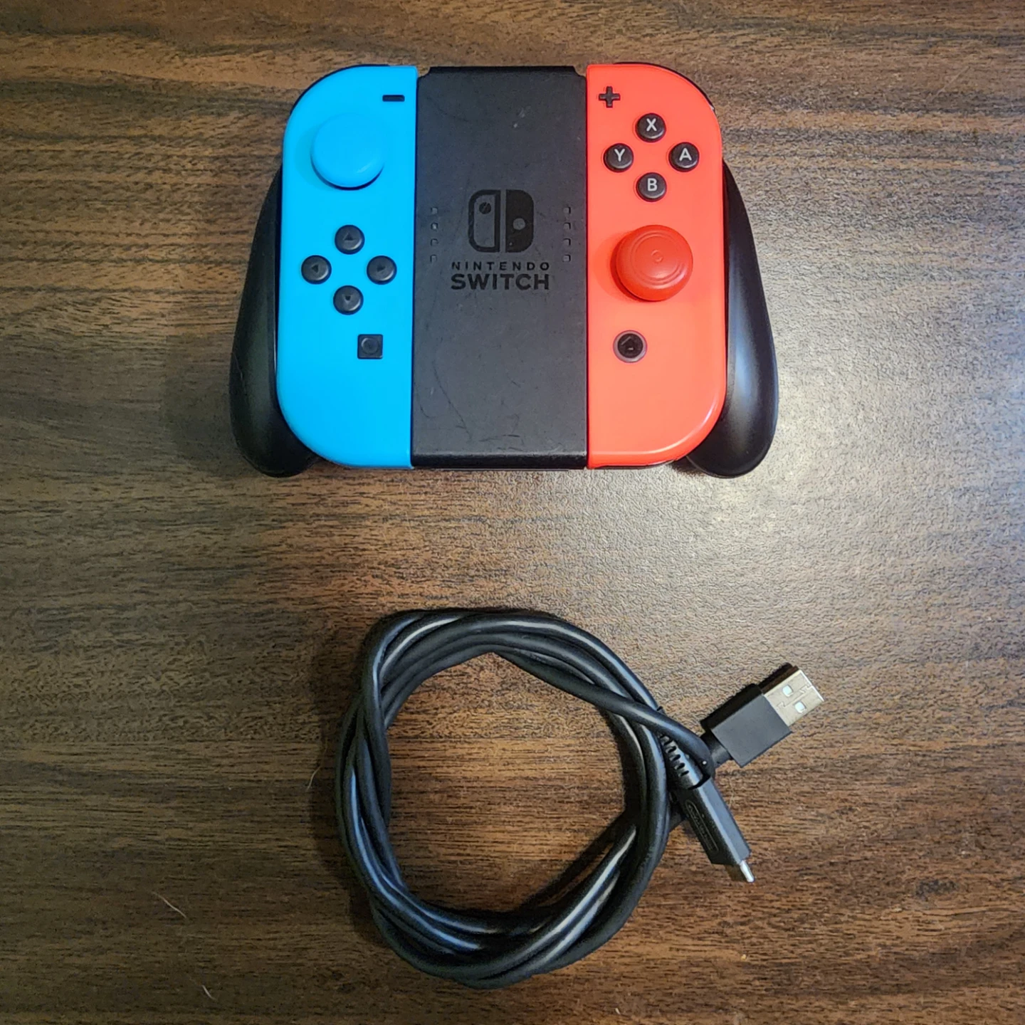 Joy cons with charger grip and connection cable.