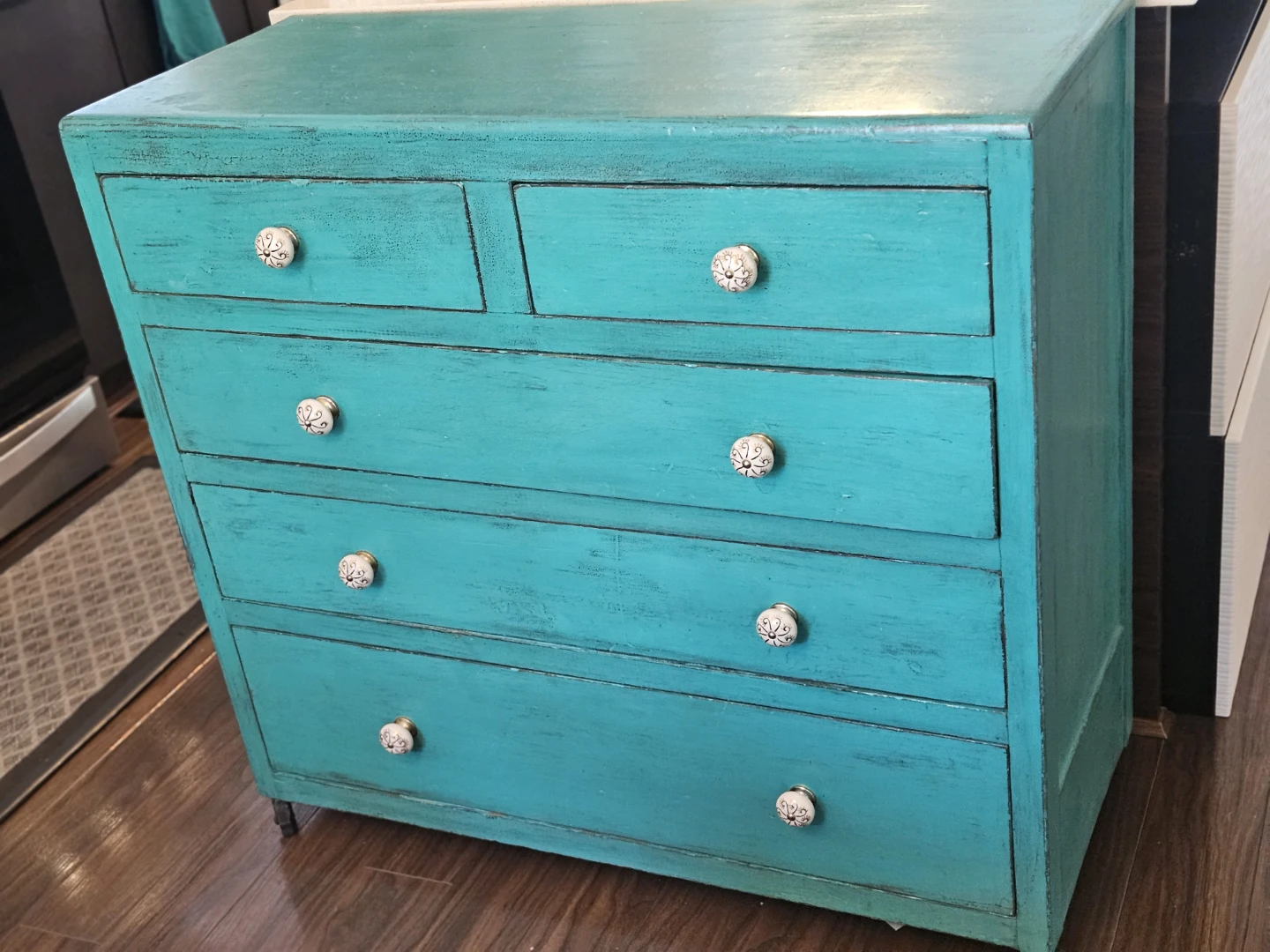 Teal Dresser with Floral Wallpaper Lining