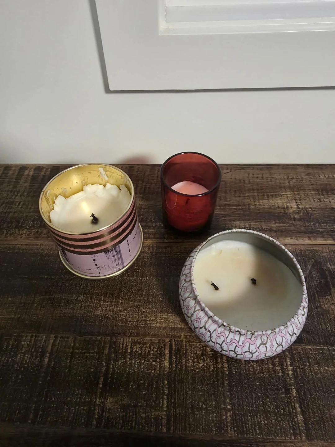 Two scented candles in decorative tins