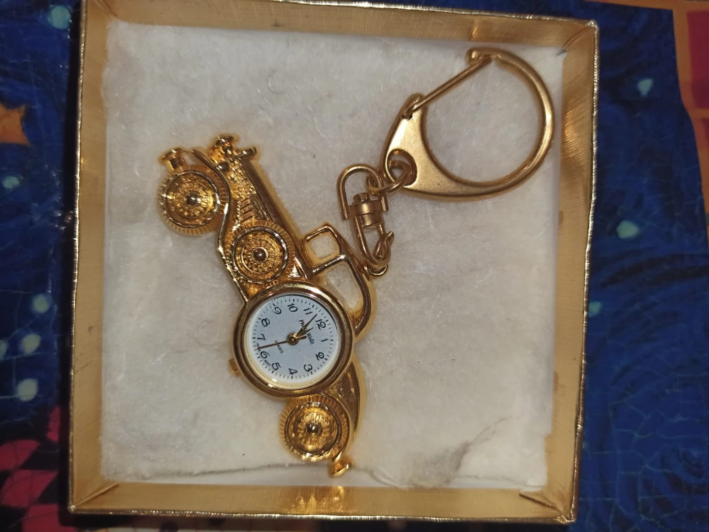 Gold coloured motorcycle keychain with watch