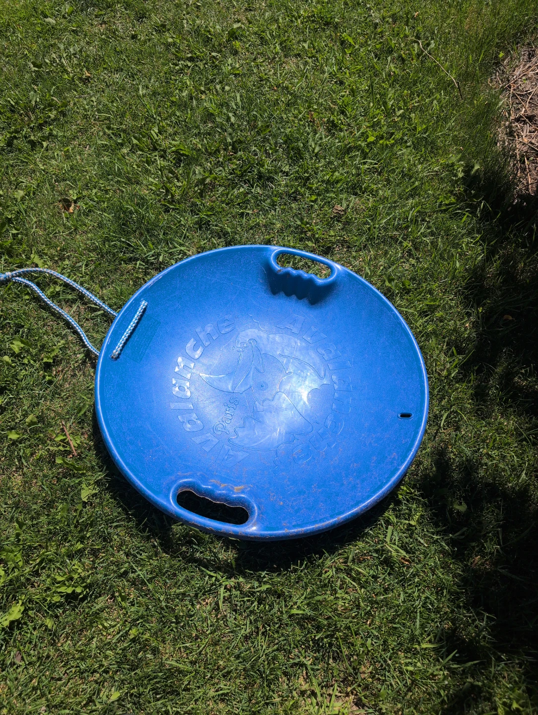 Blue "Avalanche" saucer sled with rope