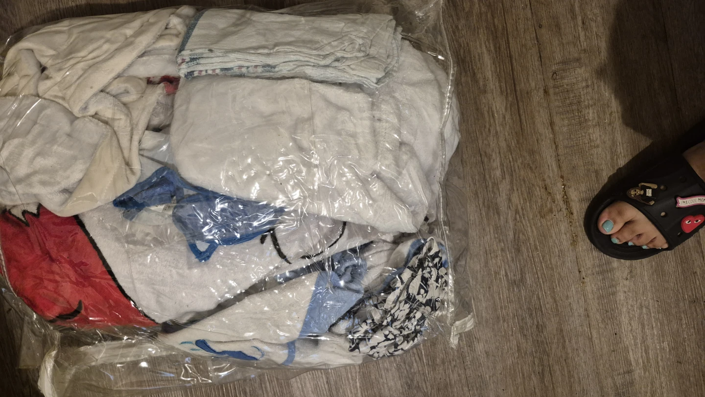 Bag of assorted baby clothes and blankets