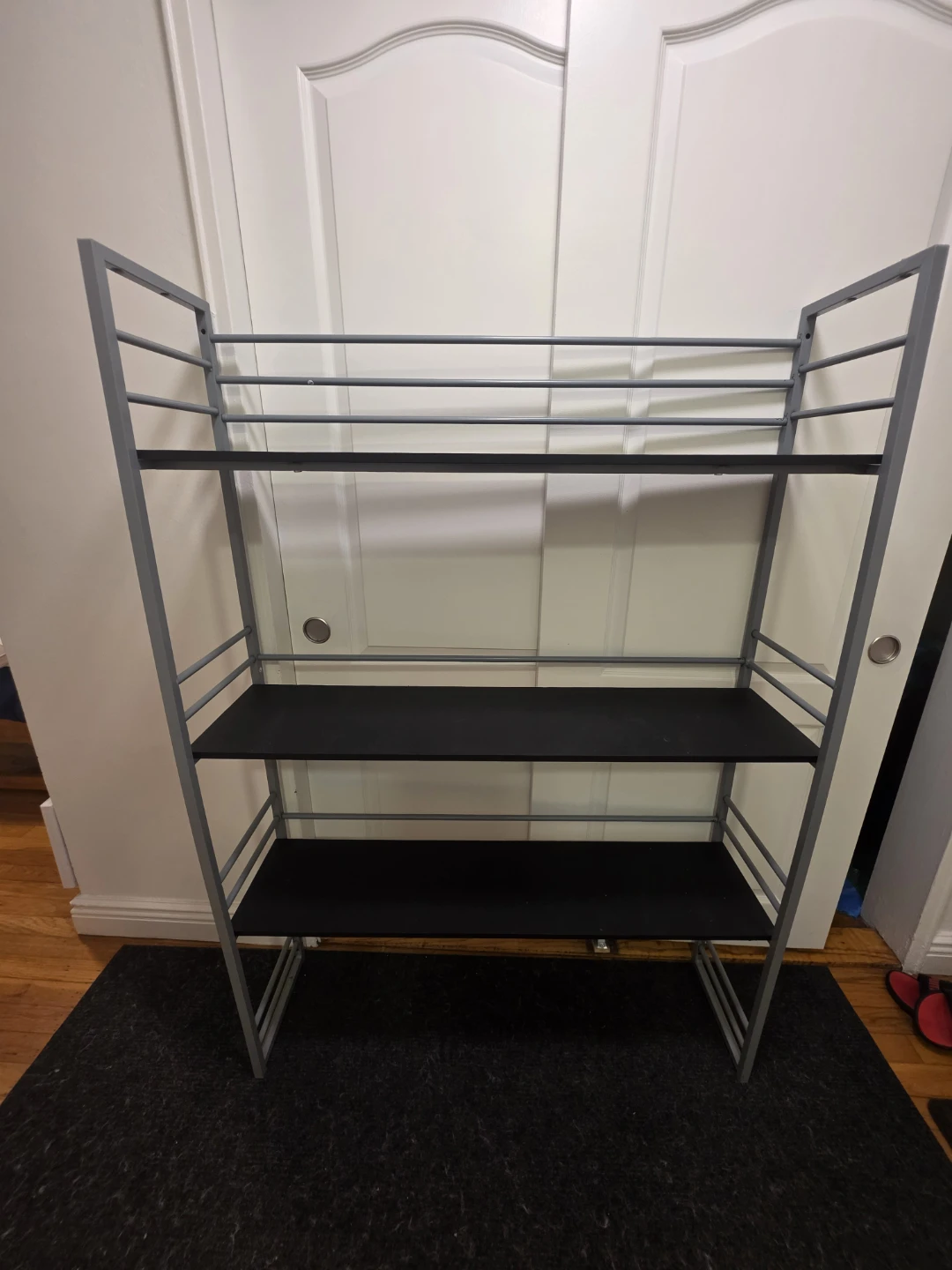 Gray metal and black shelf unit