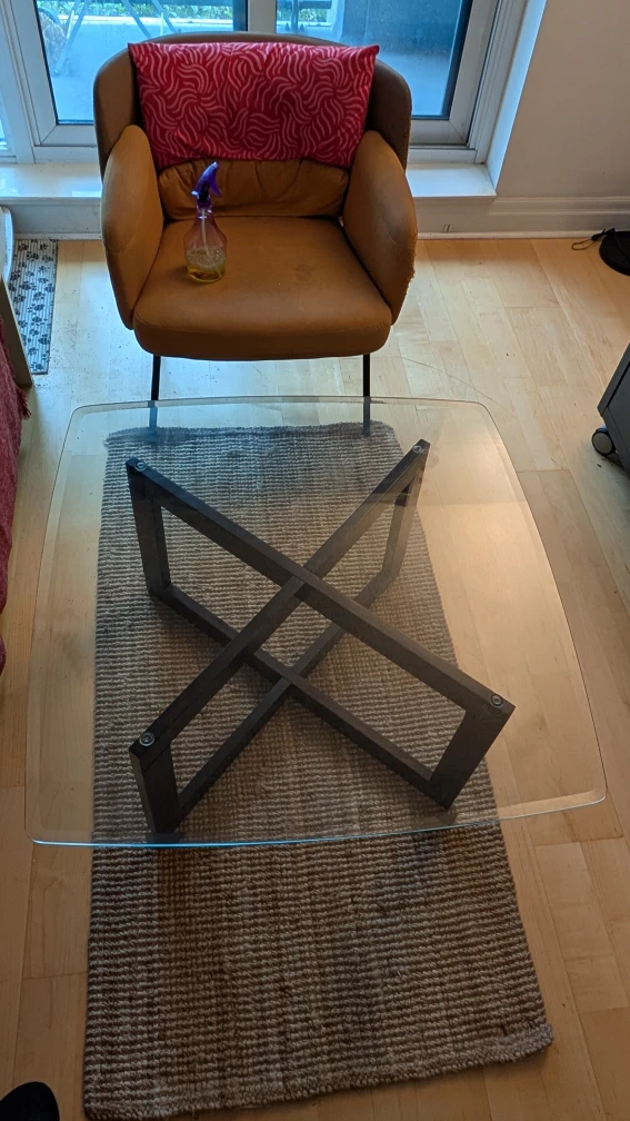 Glass coffee table with wooden base