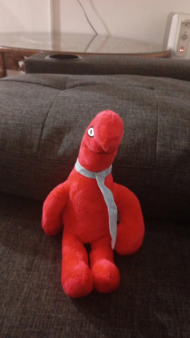 Red plush toy with light blue tie