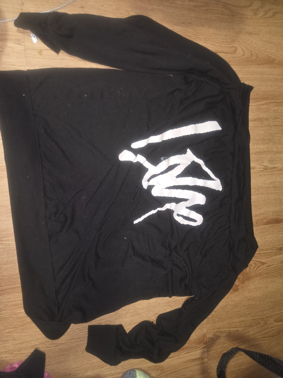 Black long-sleeved top with white graphic