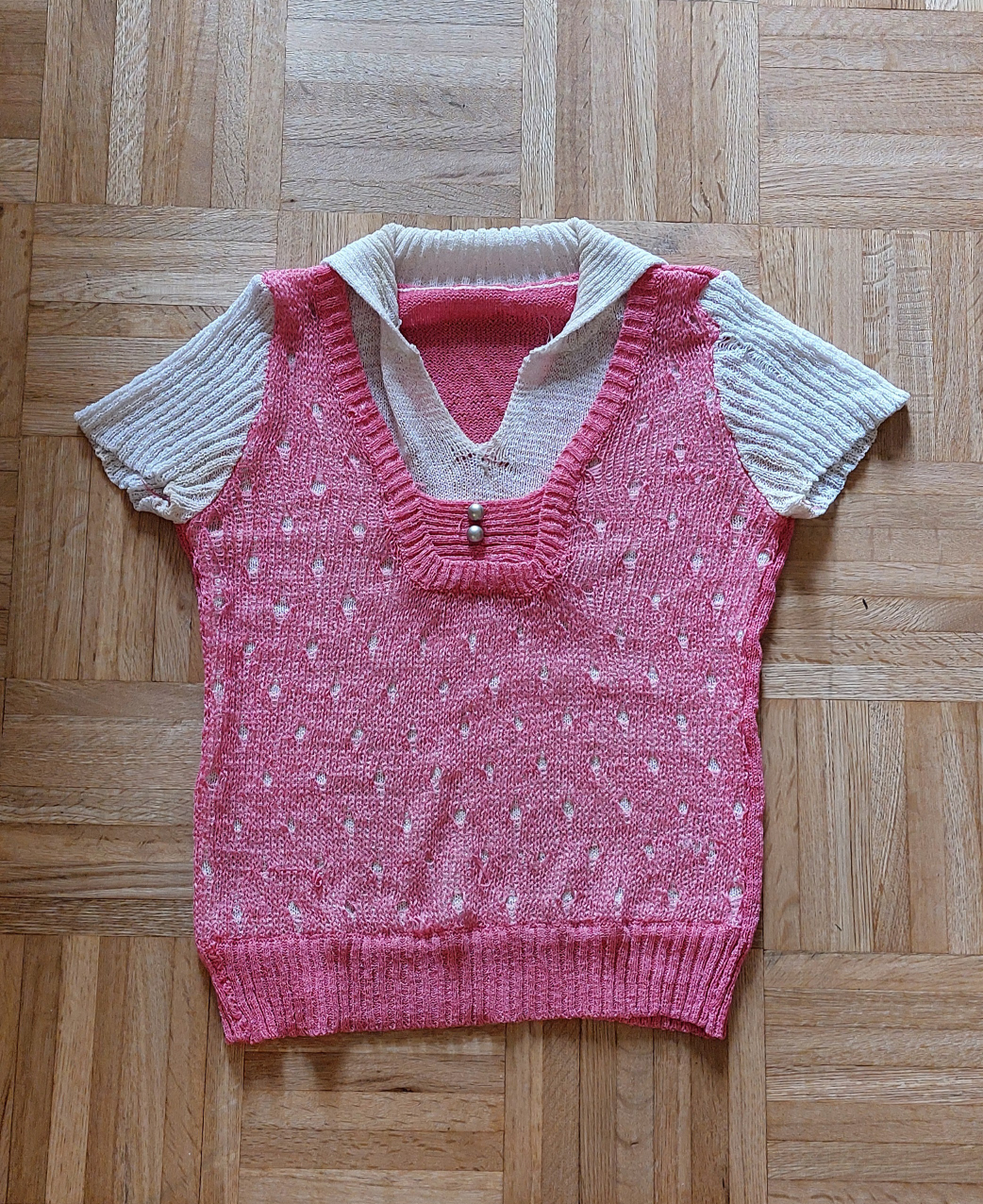 Pink knitted sweater with white sleeves