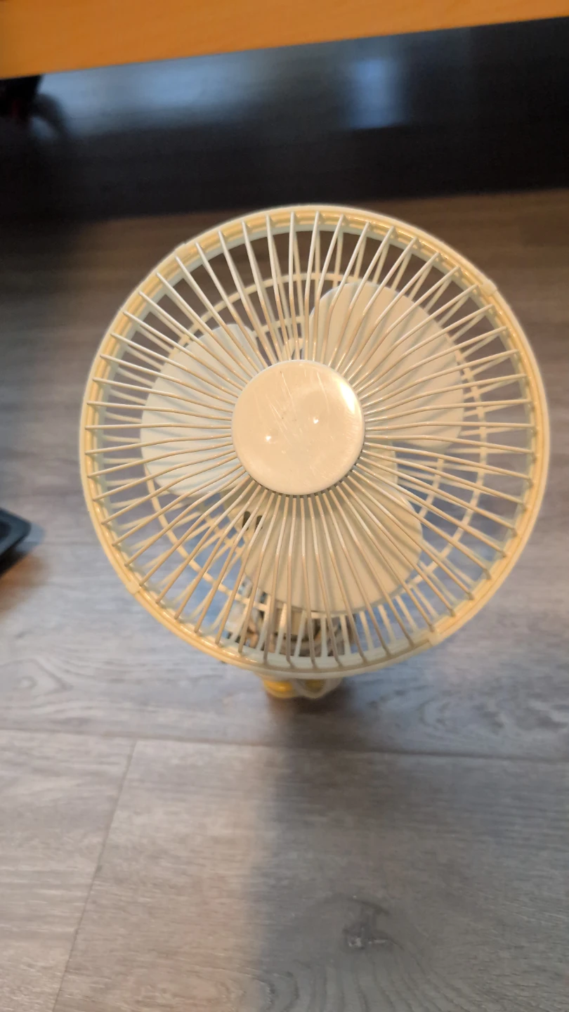 Cream coloured clip-on fan