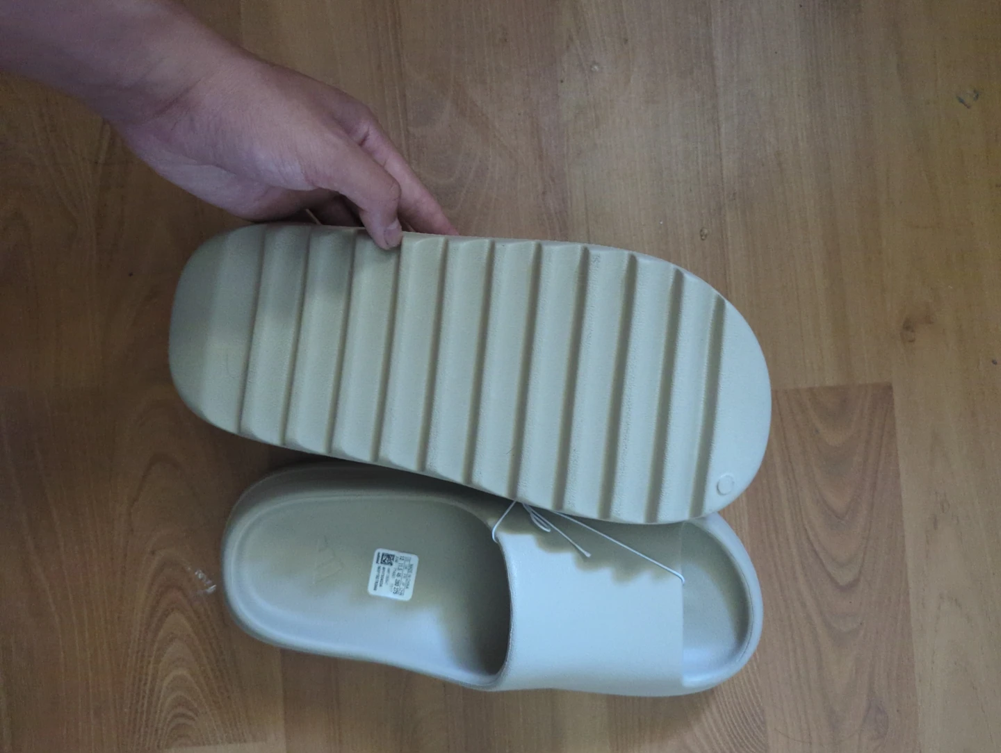 Original Yeezy slides with adidas print.