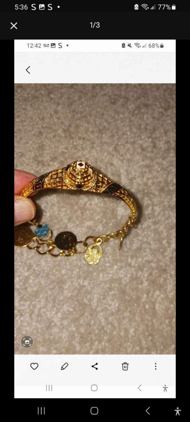 Gold coloured bracelet with charms