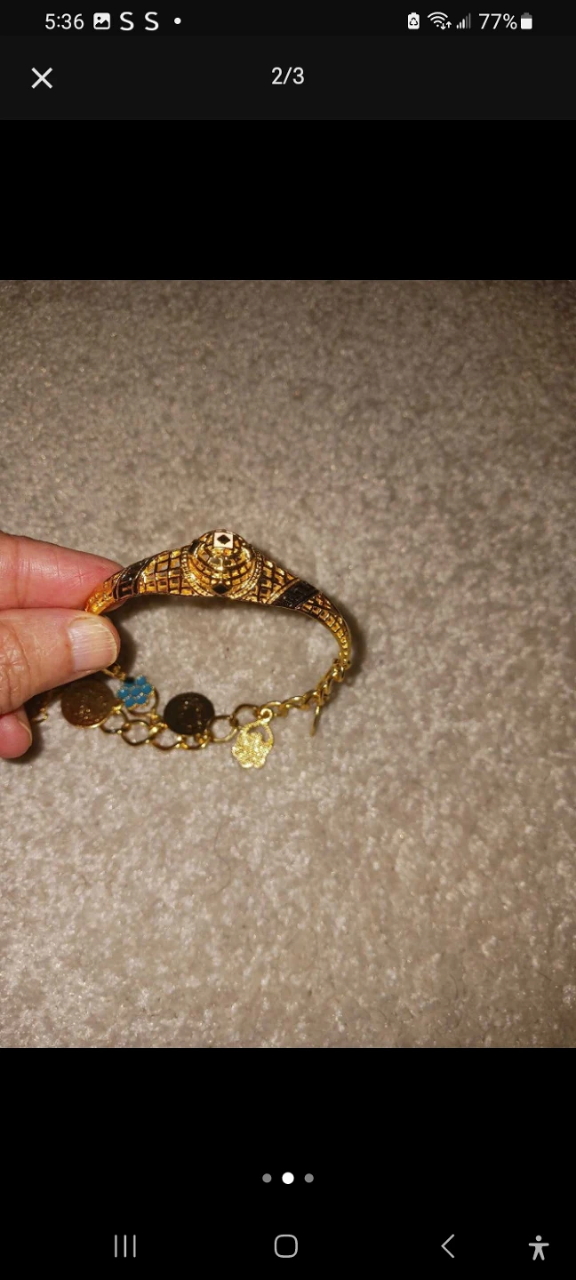 Gold coloured bracelet with charms - photo 2