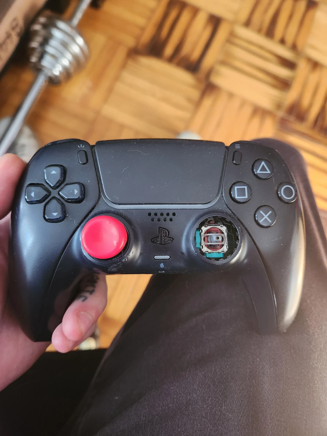 Black PS5 Controller with Red thumstick cover, missing pieces.
