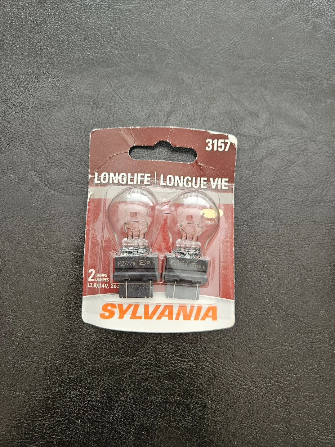 Brand‑new sealed Sylvania 3157 Long‑Life automotive bulbs.
