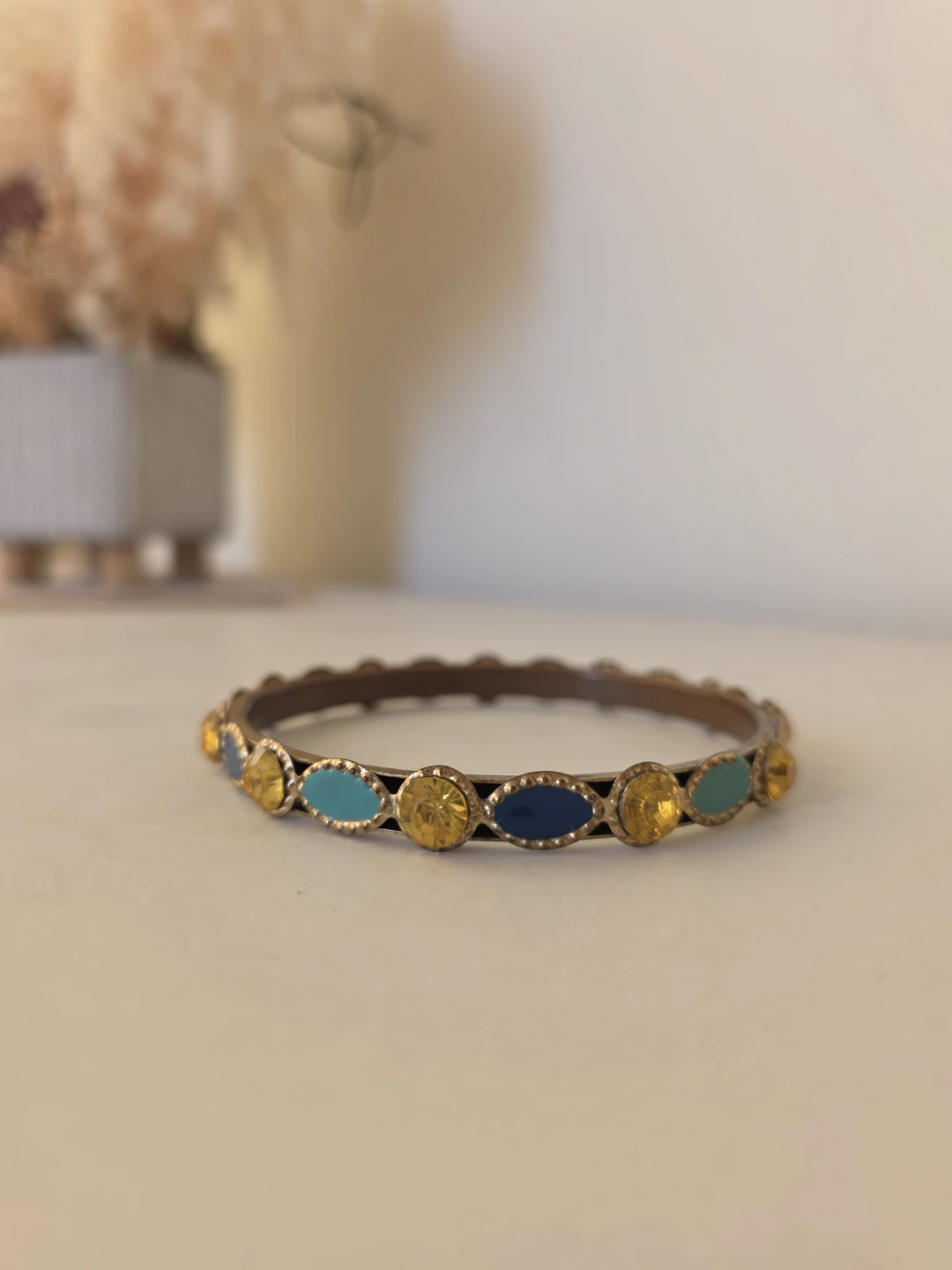 Metal bangle with enamel and crystal design