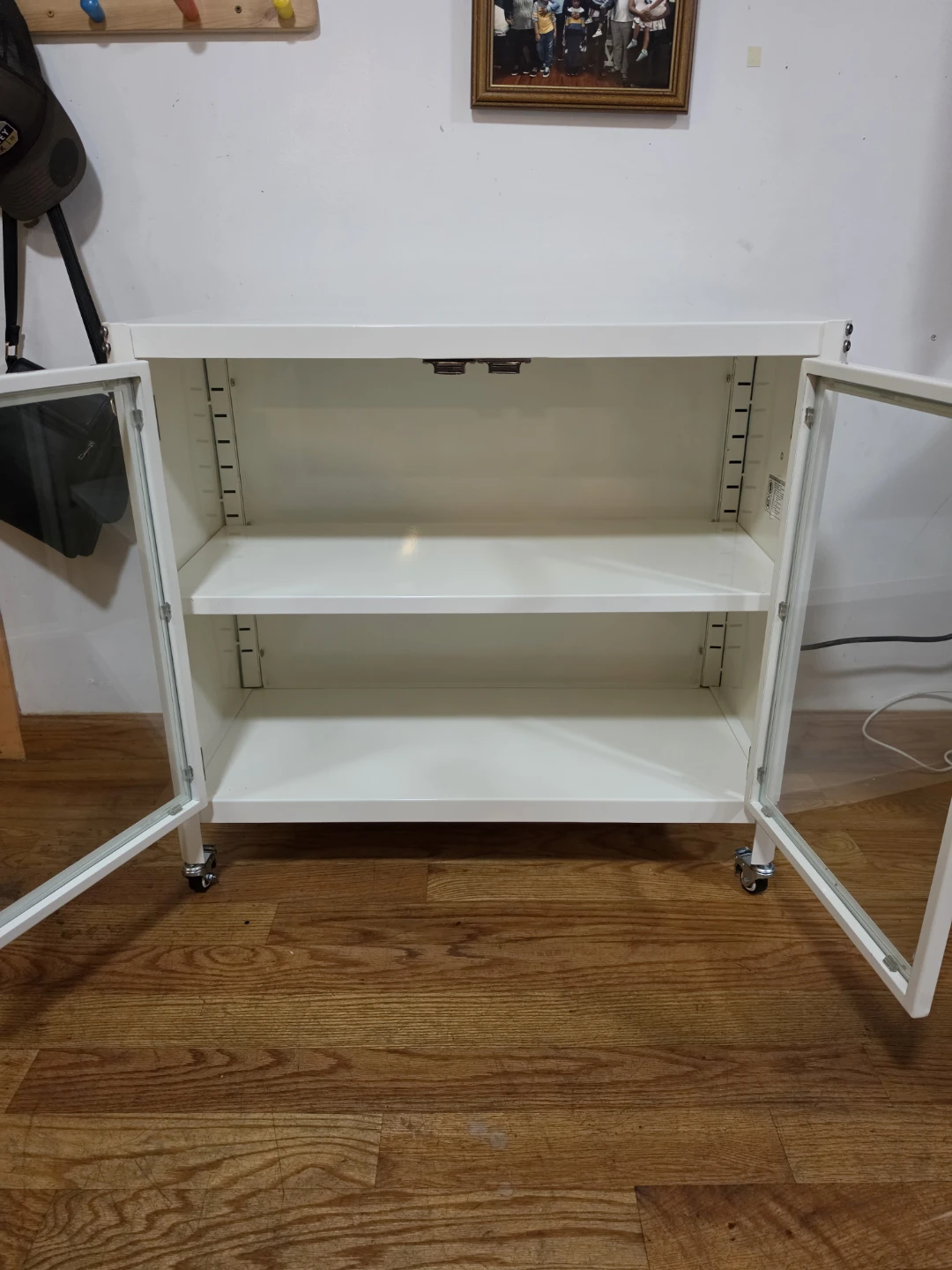 White Storage Cabinet with Glass Doors and Wheels