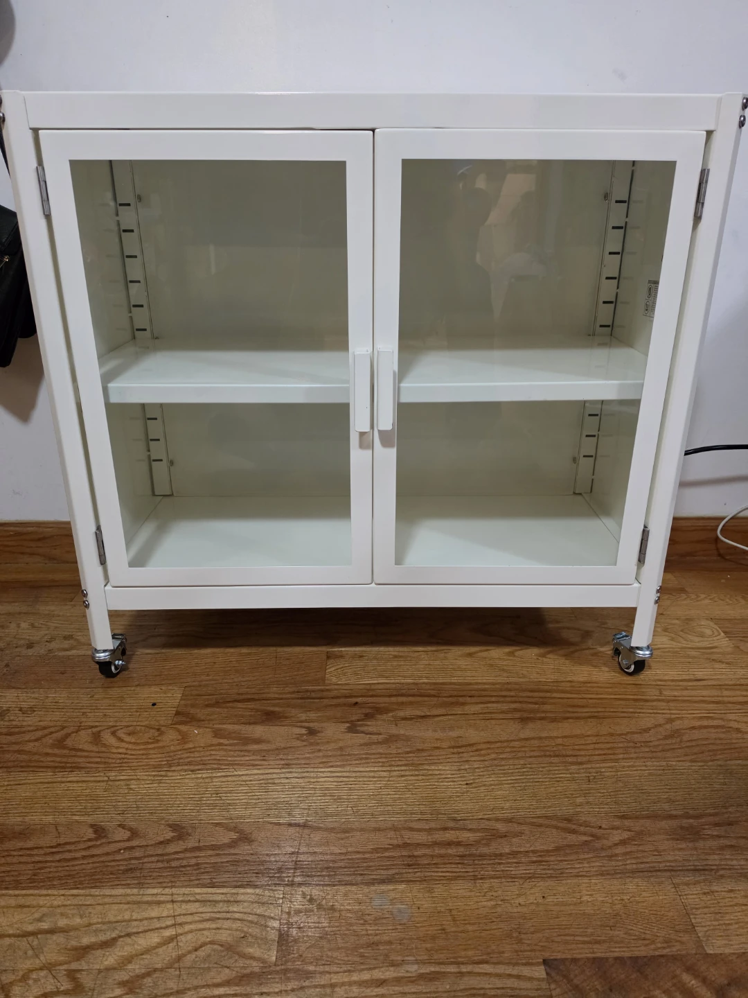 White Storage Cabinet with Glass Doors and Wheels - photo 3
