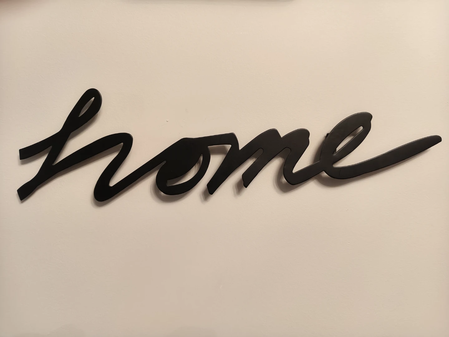 Black "home" script wall art