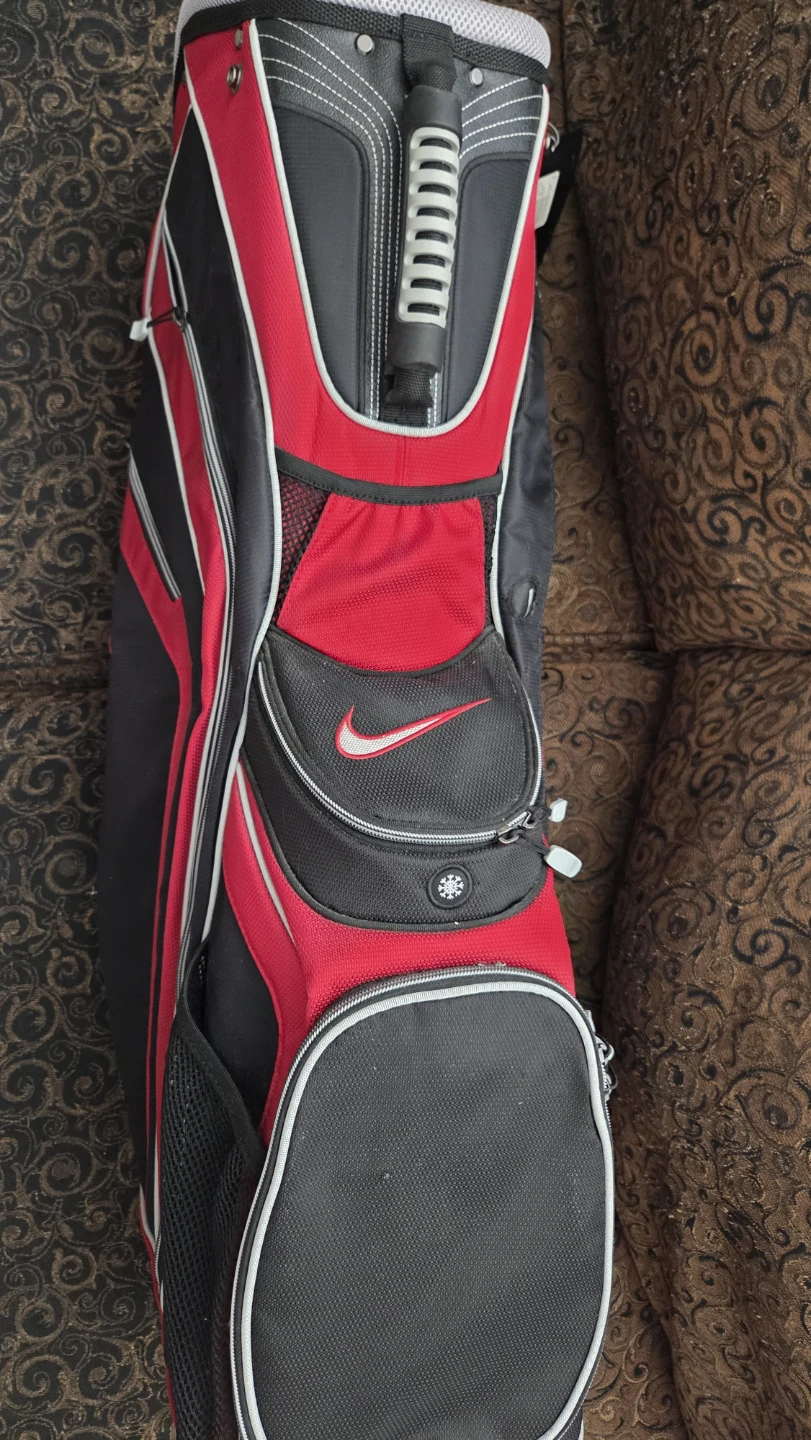 Nike 14-way cart golf bag in black and red and 2 golf clubs