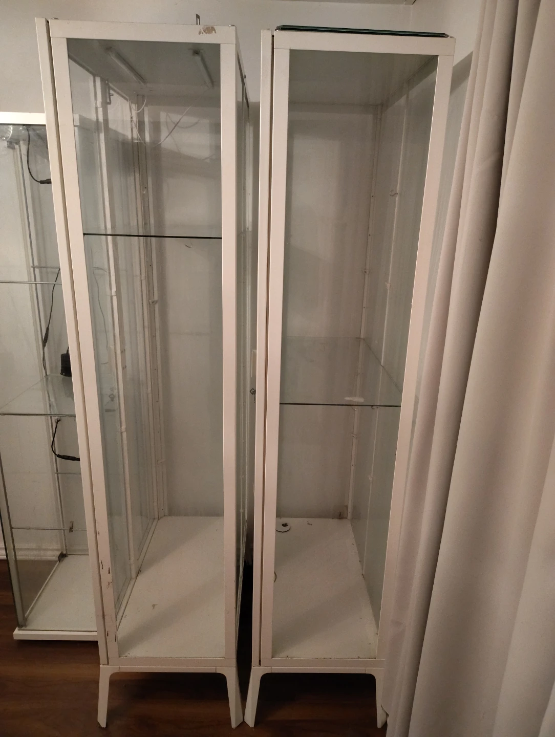 Two white display cabinets