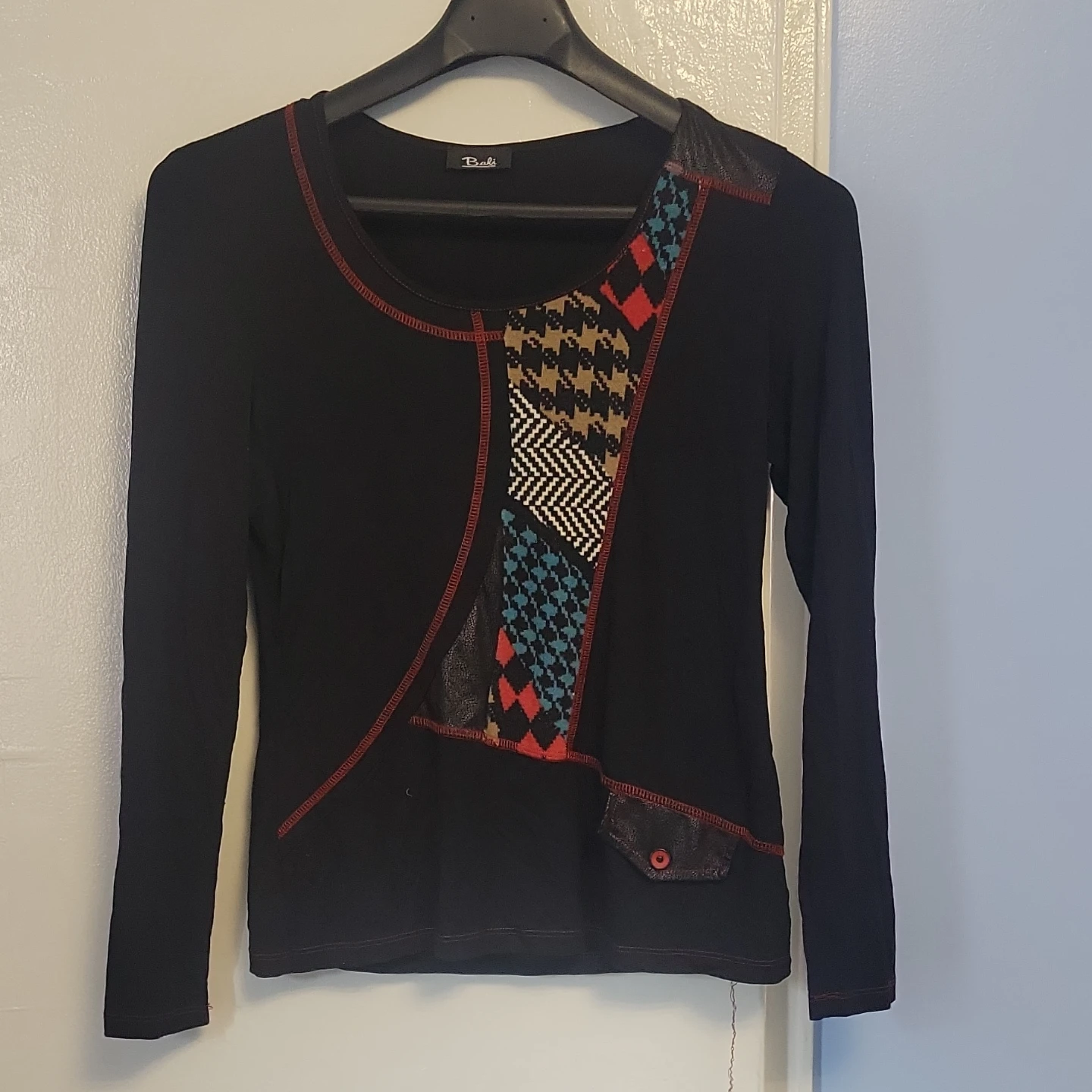 Black long-sleeve top with graphic detail